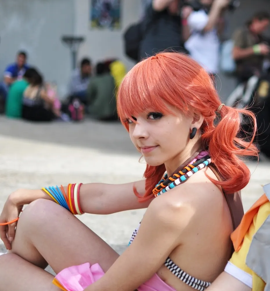 Vanille seated in profile, Final Fantasy XIII costume and beaded necklaces, cosplay by Ryuu Seika 2011