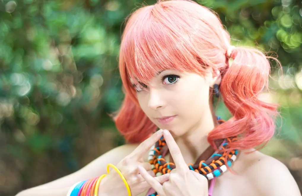 Vanille in close-up portrait, pink wig and necklaces in hand-shaped beads, cosplay by Ryuu Seika 2011