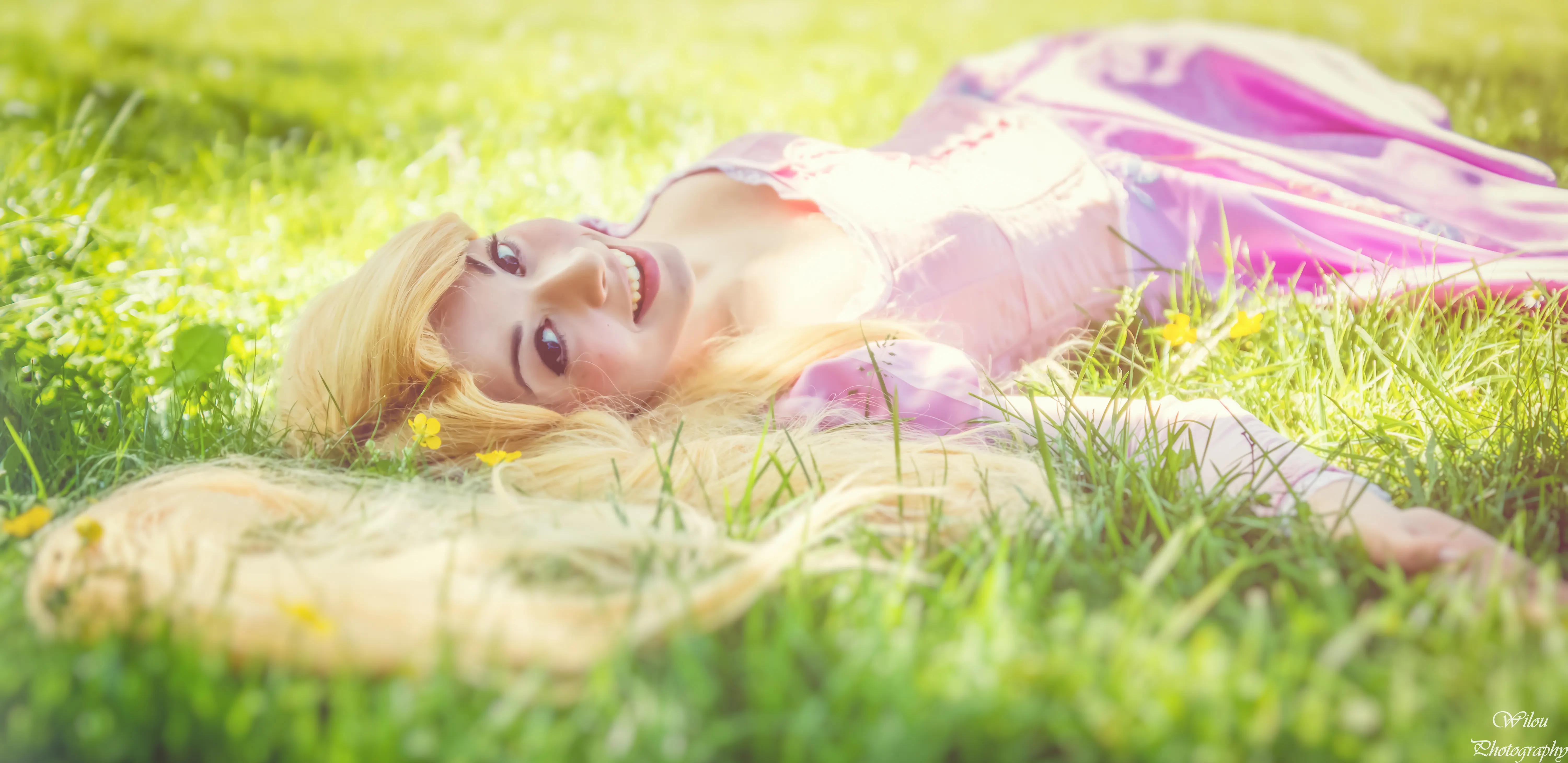 Rapunzel lying in the grass, hand-painted and hand-embroidered Disney dress, cosplay by Ryuu Seika